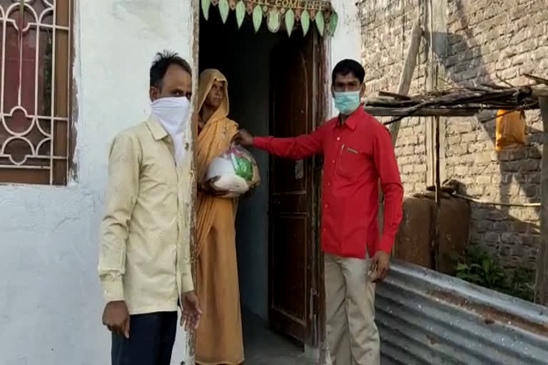 RSS workers are distributing food items to poor families