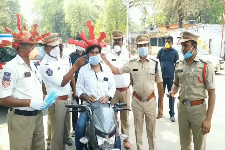 ramagundam traffic police campaigning with corona helmets in godavarikhani