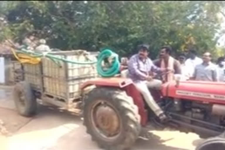 minister perni nani drive a tractor to spray the chemical water