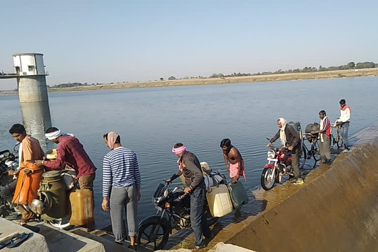 People crossing the river putting their lives at risk