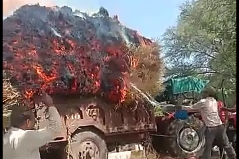 Tractor carrying crop barn from fire circuit