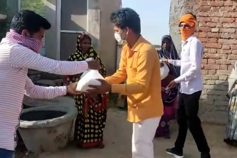 youth providing food to needy people