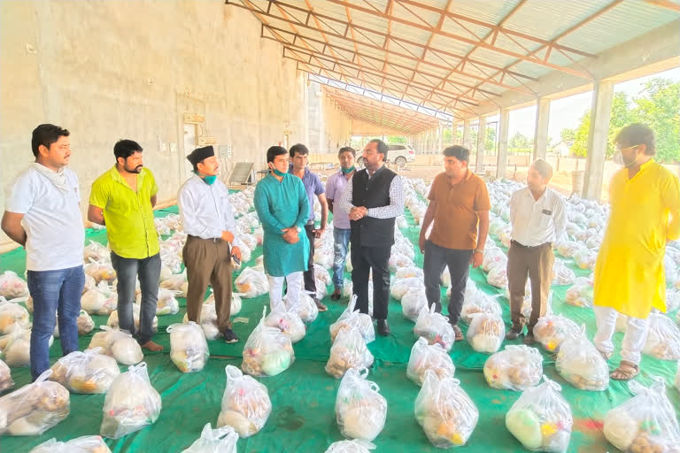 a young man distribute food kit to needful people