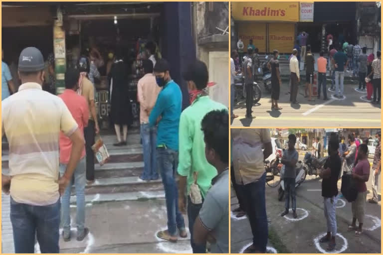 People line up outside a liquor shop in Dibrugarh as government permits sale of liquor between 10 AM & 5 PM during CoronavirusLockdown.