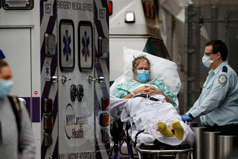 Patients and medical workers wear personal protective equipment due to COVID-19 concerns outside the emergency room at NYU Langone Medical Center