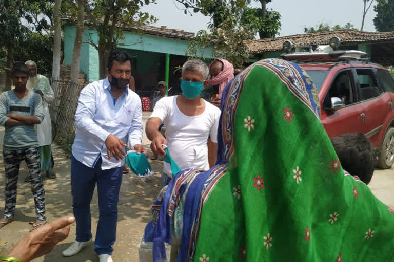 Congress district president Mohammad Asad distributed masks soap among the people