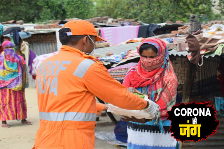 NDRF team distributes ration materials to the needy by doing sanitization in Ghaziabad corona virus