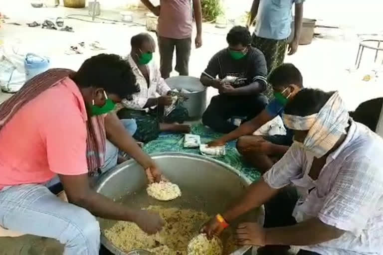 Younger people handing out food packets to the poor