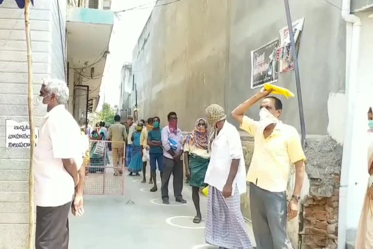 Beneficiaries of physical distance in front of the Andhra Bank in rajam