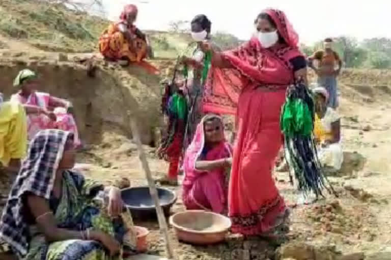 Anganwadi workers distribute masks to MNREGA workers