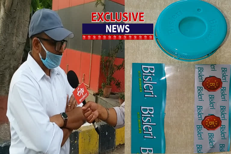 4 people selling local water in branded company bottle