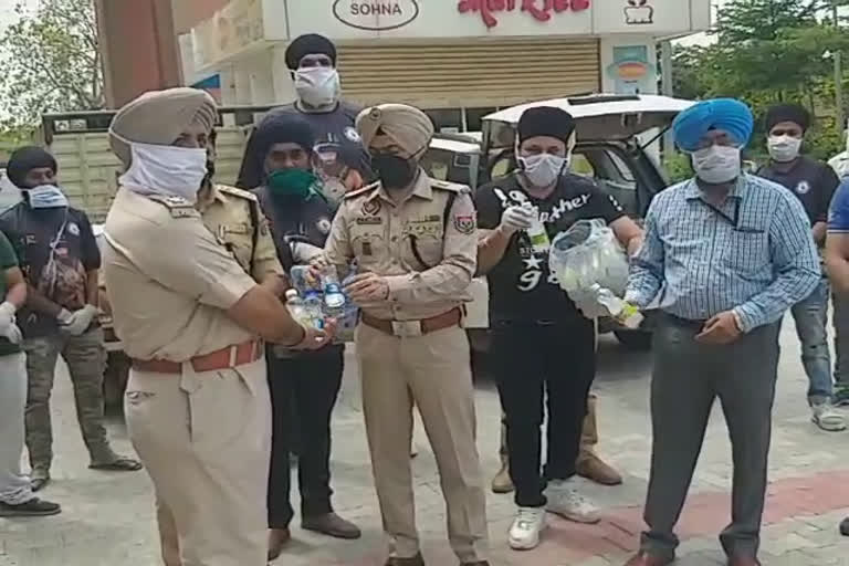 social workers distribute water bottle to duty man in tarn taran