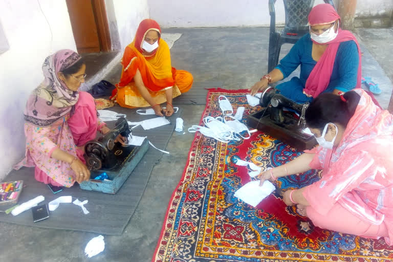 Womens making masks at home in lockdown