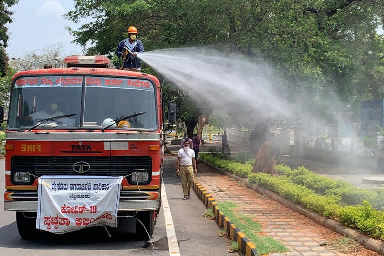 Cleaning work by Fire Brigade officers in front of Mysore Government Office