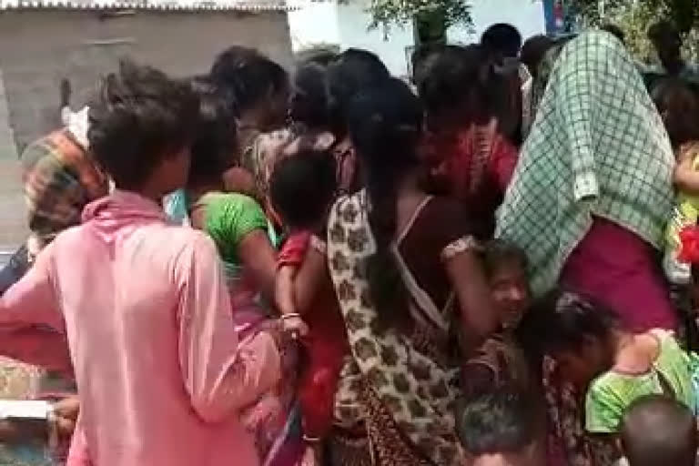 Ladies grouped up to receive food grains by breaking social distance