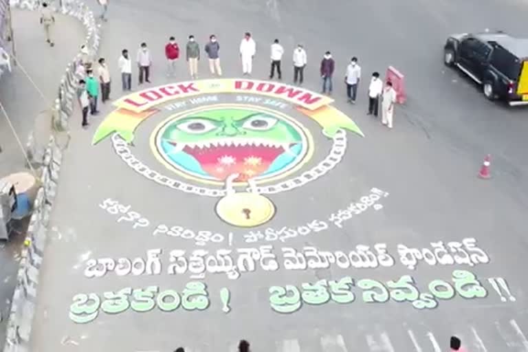 drawing on road for corona virus awareness in hafeezpet