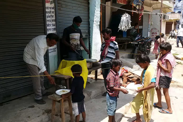 A family is distributing food to hundreds of people in latehar