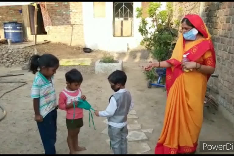 4-year-old child together with father distributed masks to village children