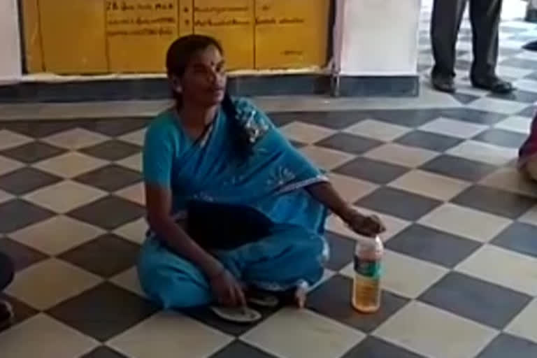 Woman agitated with patrol bottle in front of tahsildar's office i nramakuppam