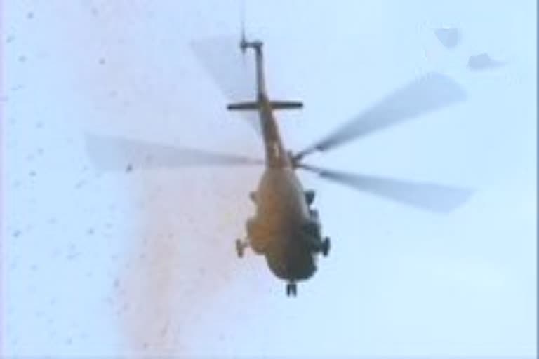 Chopper of the Indian Air Force showers flower petals on the Police War Memorial