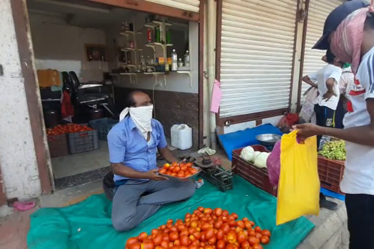 saloon shop keepar selling tomatoes in murbad