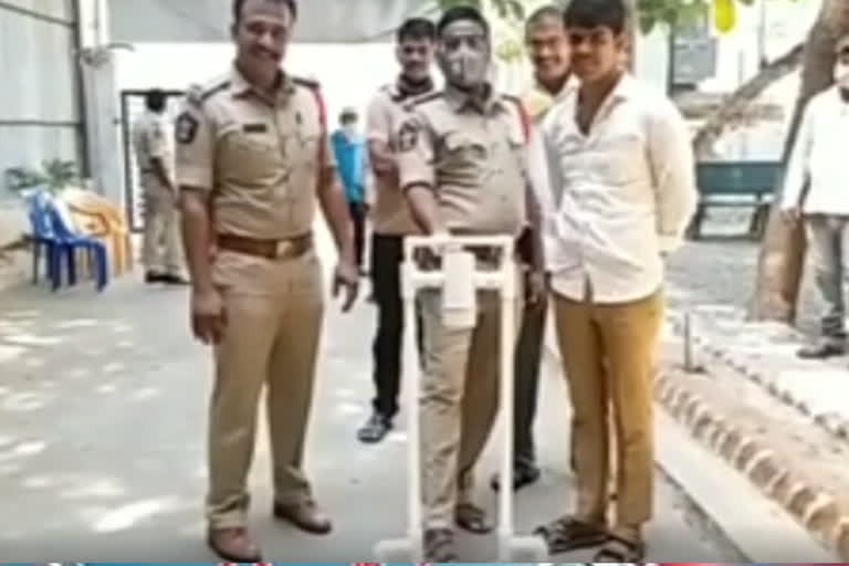 a boy donate machine use to  clean hands with sanitazer  to police in kurnool dst