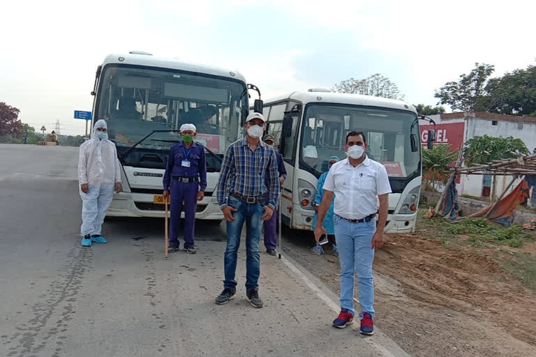 Workers walking from Katghora are going by bus