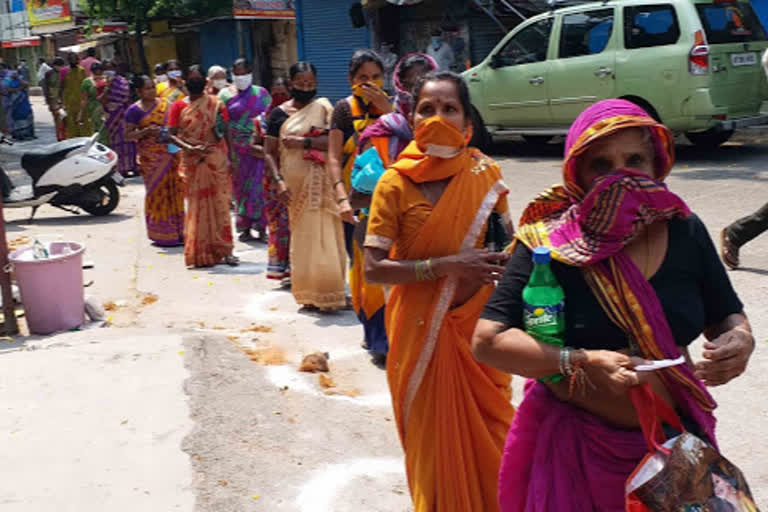 Women in queue while collection free ration in New Delhi