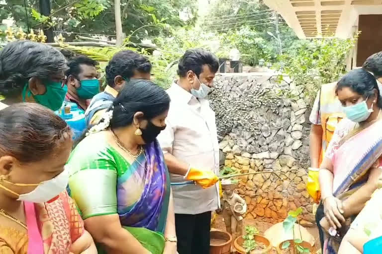 minister-thalasani-spraying-chemicals-at-home in west maredpalli