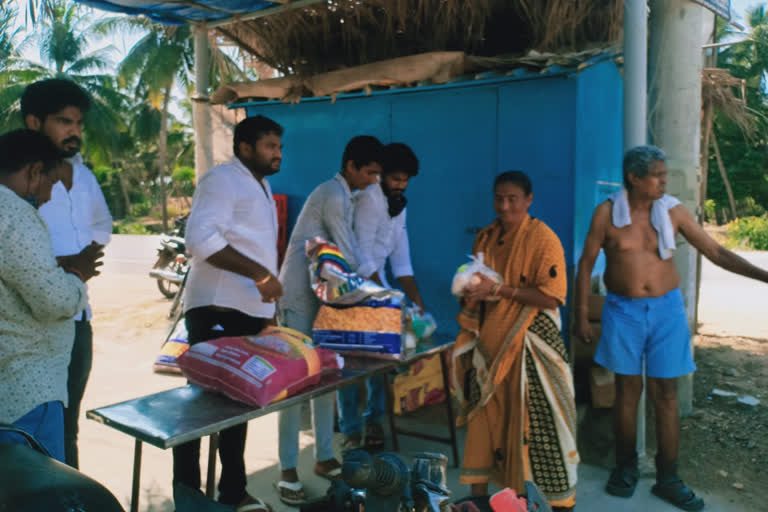 sons distributing essentials to poor people on his memorable day in narasapuram