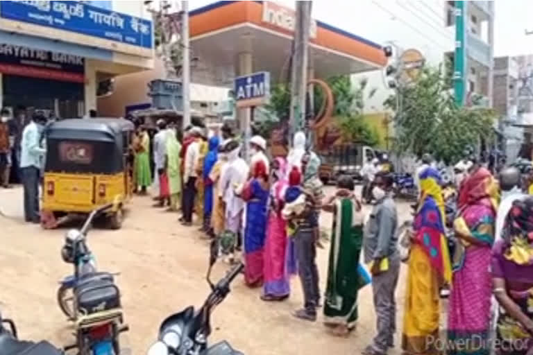 People were standing at a private bank in Kamareddy without a physical distance