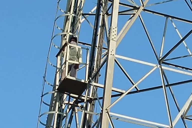 one man protest on the cell tower in karimnagar district