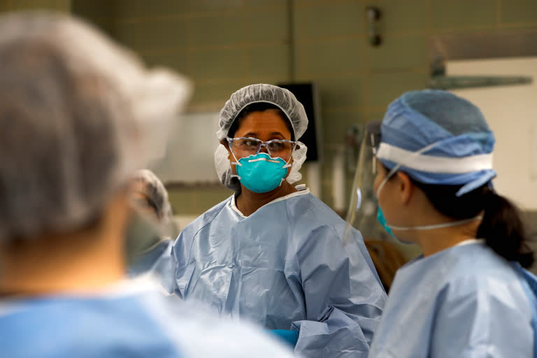 Cook County Chief Medical Examiner Dr. Ponni Arunkumar, conducts rounds, an overview of cases for the day, with her medical staff of six fellow pathologists who will perform several autopsies on shooting victims and others whose cause of death isn't clear at the county morgue in Chicago