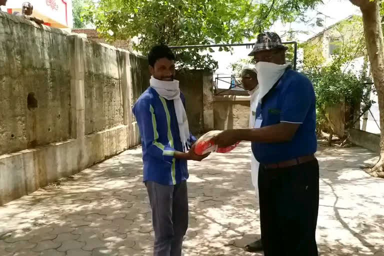 Municipality employees going in wards and distributing ration to the needy