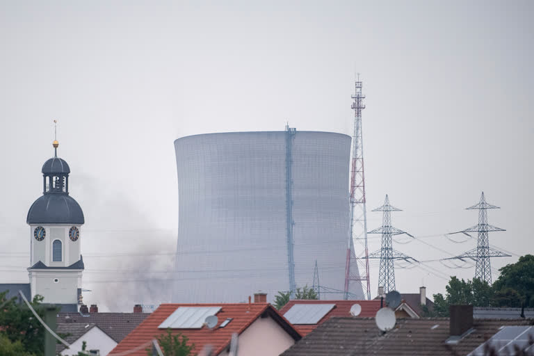 The cooling towers of the decommissioned nuclear power plant collapse after being blown up in Philippsburg, Germany, on Thursday.