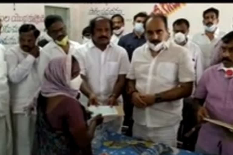 minister balineni srinivas reddy distributed  checks