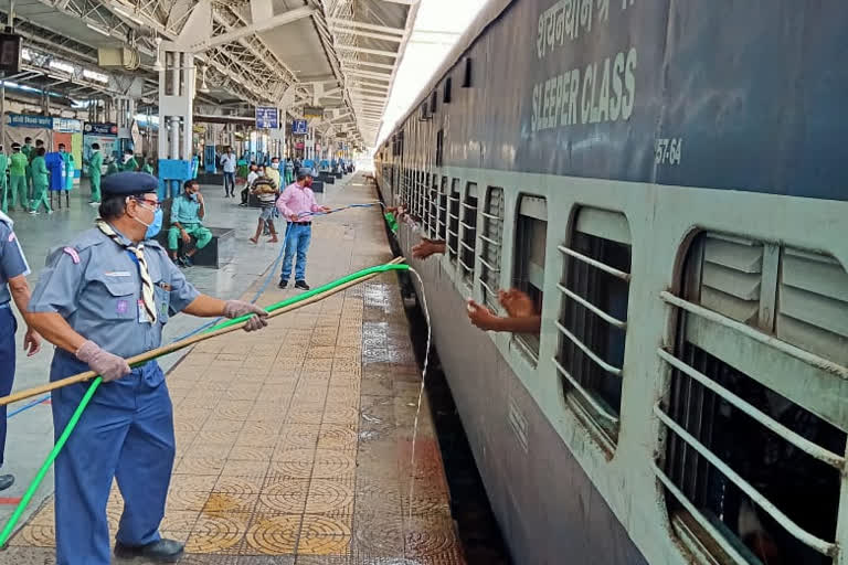 Scout guide's team serving water to passengers of shramik express in itarsi of hoshangabad