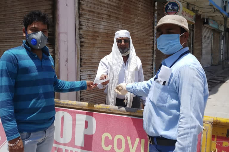 Employees bringing money from the bank to the people of the containment area