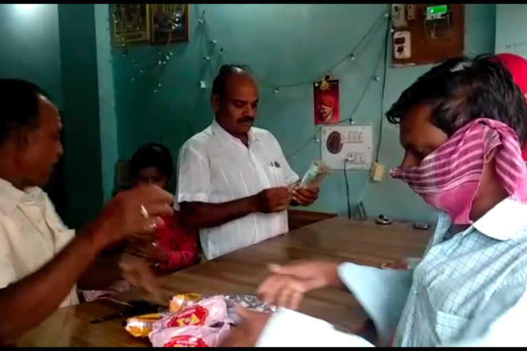 people standing queue for tobacco purchase in bellary