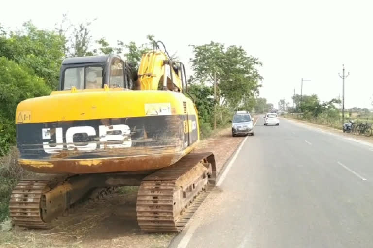 Jcb stands on the road side