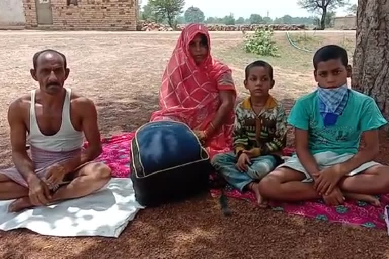 Quarantined family with children under peepal tree