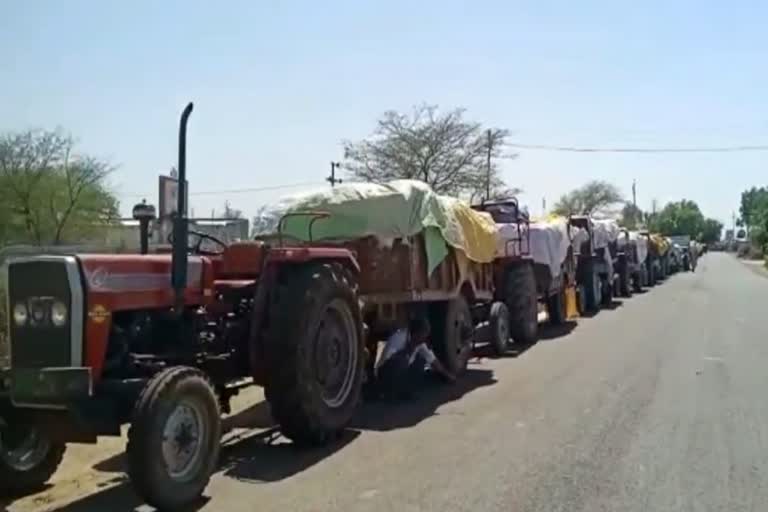 Tractors in line of procurement center