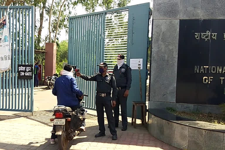 Checking the temperature of employees at NIT gate in raipur