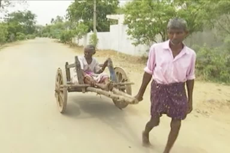 Son carrying old mother in wooden car to take pension