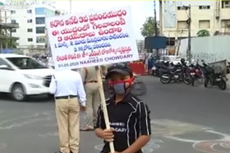 a boy awareness on corona in vijayawada