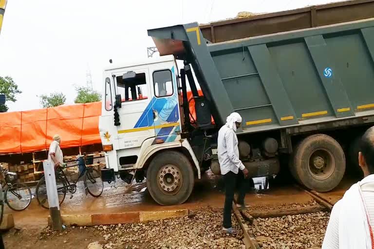 Truck stuck in the middle of railway crossing