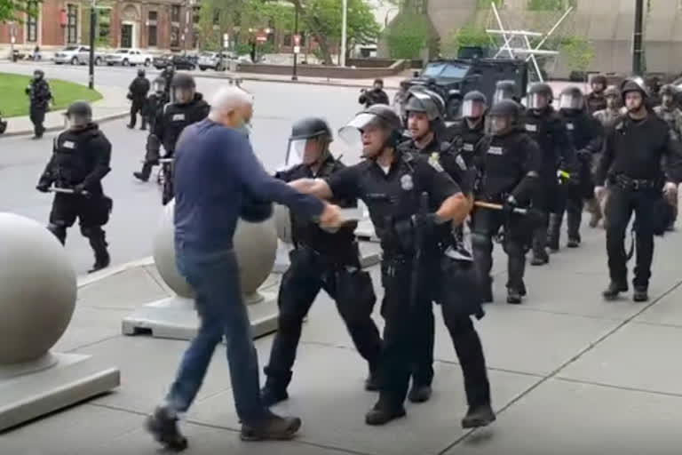 A Buffalo police officer appears to shove a man who walked up to police on Thursday.