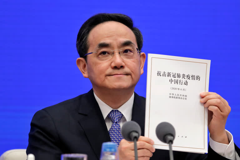 Xu Lin, Vice head of the Publicity Department of Communist Party showing a copy of the white paper on fighting COVID-19 China in action during a press conference at the State Council Information Office in Beijing, on Sunday.