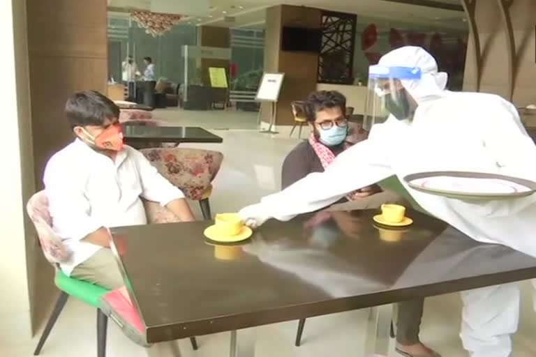 Staffers of a hotel in Patna seen serving its customers while wearing PPE kits.