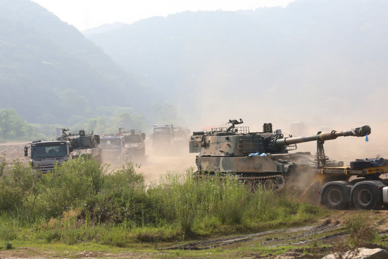 South Korean army's K-55 self-propelled howitzers loading on vehicles are moved in Paju, near the border with North Korea, South Korea, on Wednesday.